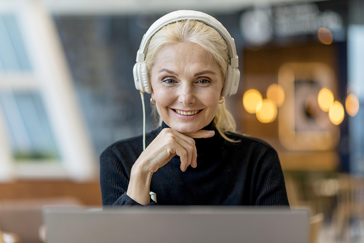 smiley-older-woman-conference-with-headphones couple on a video call
