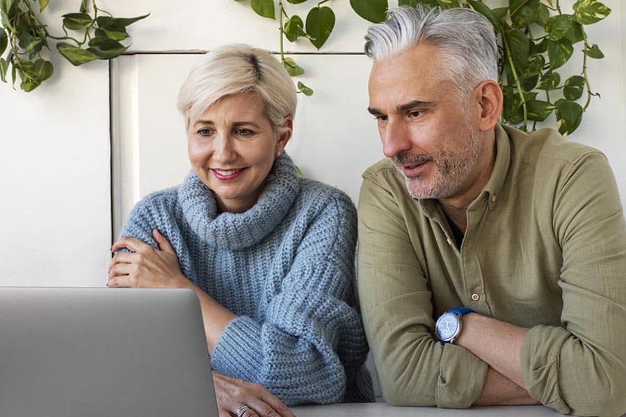 older-woman-home-talking-phone-while-having-coffee